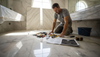 Installer prepping spacious marble bathroom