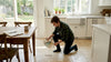 Homeowner inspecting tumbled travertine kitchen floor