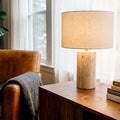 Travertine lamp glowing in elegant living room