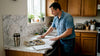 Worker installing marble laminate in real kitchen