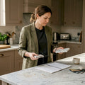 Designer compares marble samples in home kitchen