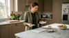 Designer compares marble samples in home kitchen