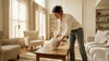 Woman placing artisanal stone vase in living room