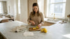 Person slicing lemons on honed marble kitchen island
