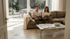 Couple relaxing in travertine-tiled living room