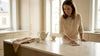Woman cleaning marble kitchen island surface