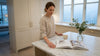 Woman reviews brochures in Carrara marble kitchen