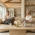 Couple reading in living room with marble coffee table
